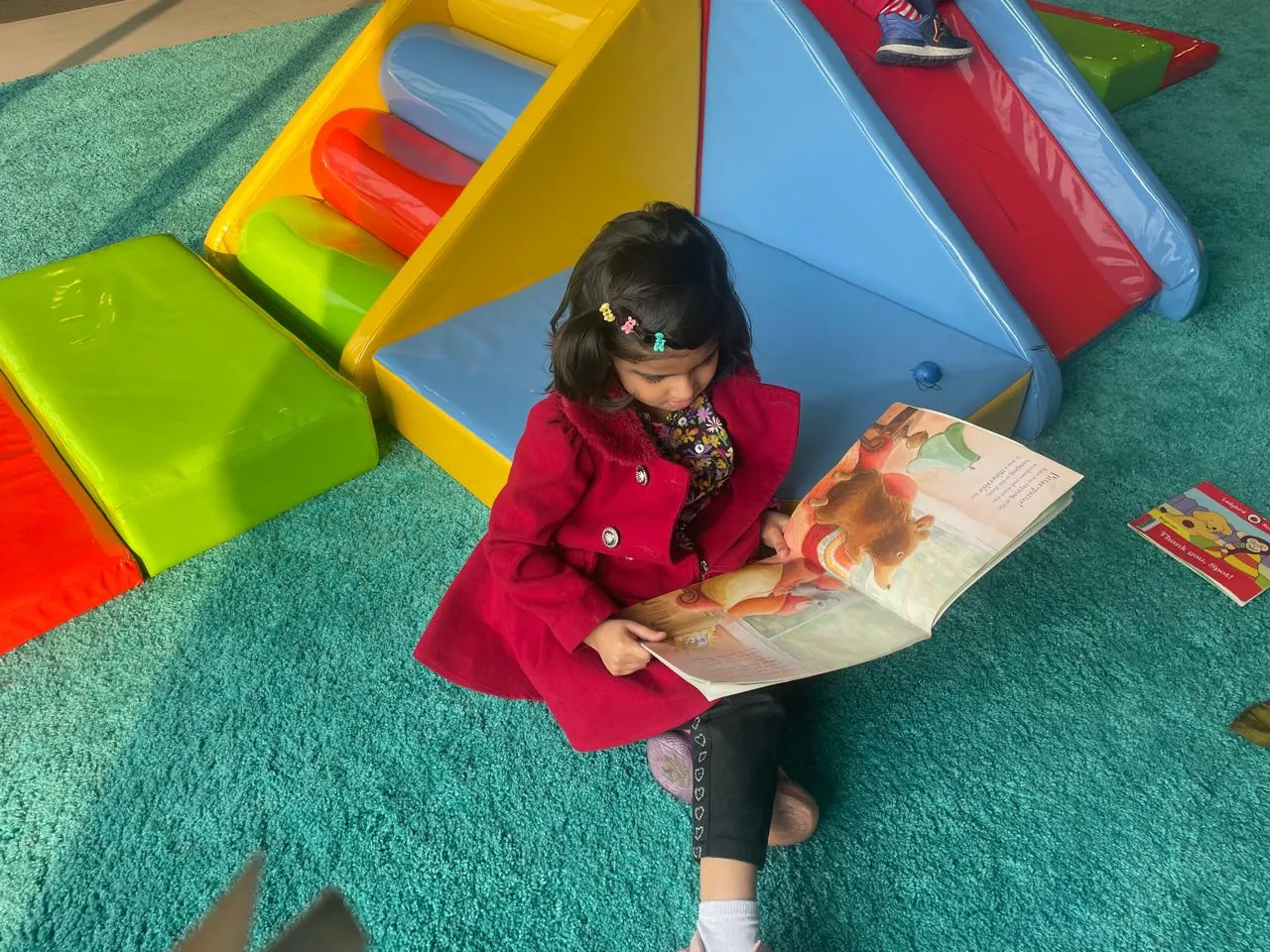 A young child reading during a quiet literacy moment